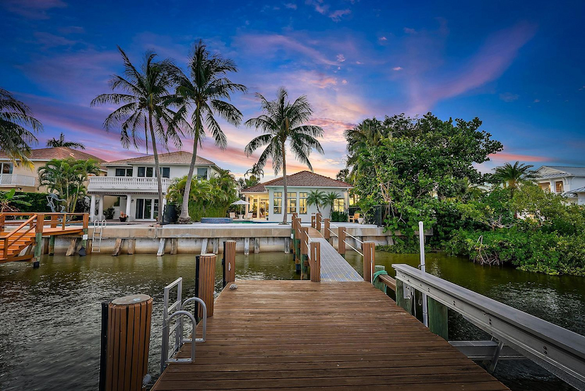 COMPLETELY REIMAGINED WITH WIDE INTRACOASTAL VIEWS IN GATED COMMUNITY
